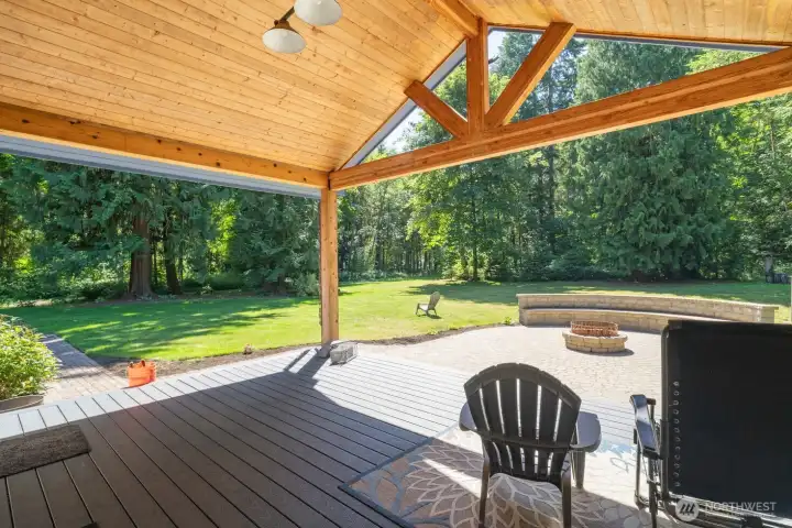 Covered deck off living room with firepit, cedar siding Covered deck off living room with firepit, cedar siding