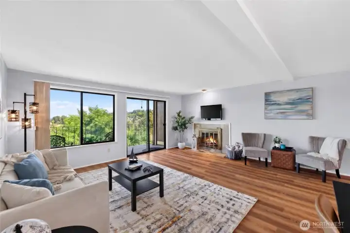 Bright and spacious living room featuring large windows that flood the area with natural light, perfect for entertaining and comfortable everyday living.