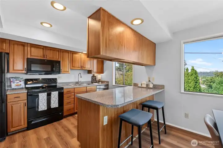 Newer appliances, plenty of storage w/eat in bar make this kitchen space the heart of the home.