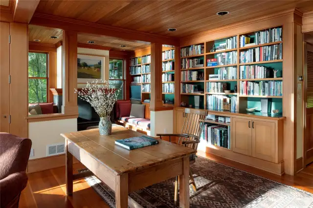 Some of the walls of built-in fir bookcases looking toward the Inglenook.