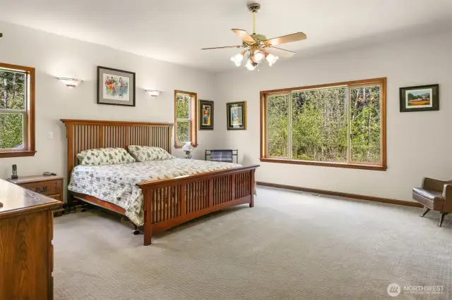 Spacious Primary Suite - light and bright with large windows bringing nature indoors.