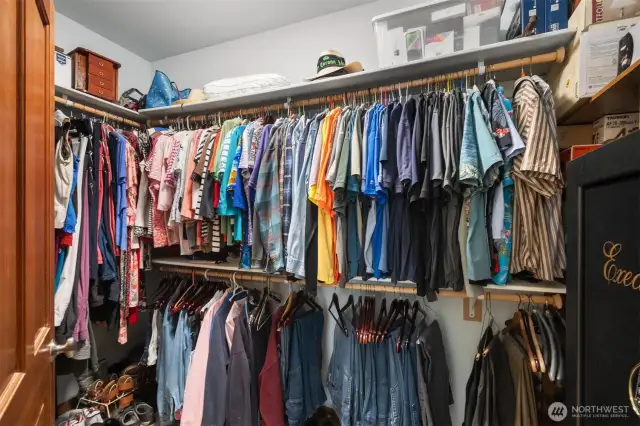 Primary walk-in closet with shelving and rods plus room for your safe