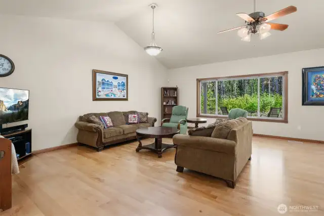 Soaring vaulted ceilings grace the Great room, combining Living, Dining, and Kitchen.