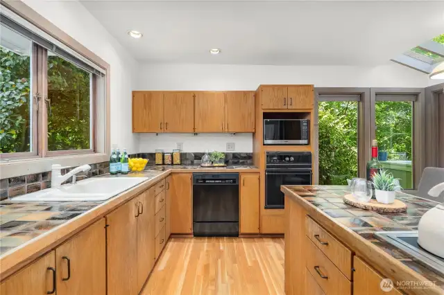 Beautiful tile in kitchen, with eating space that opens to deck.