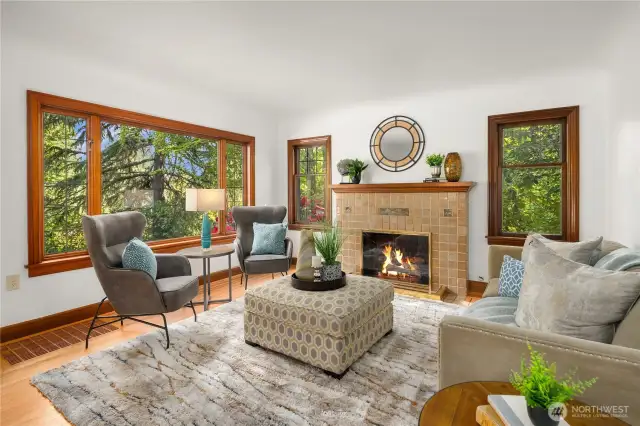 Living room has gas converted fireplace with Batchelder tiles