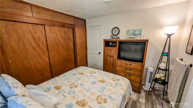 Comfortable and cleverly arranged, this second bedroom offers serene style and standout storage with a wall-to-wall closet.  A flexible space that combines coastal charm with practical design for easy, breezy functionality.
