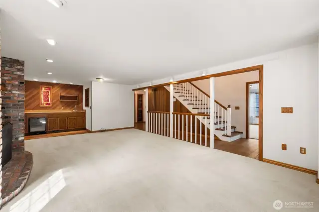Large entertaining room with wet bar and wood fireplace.