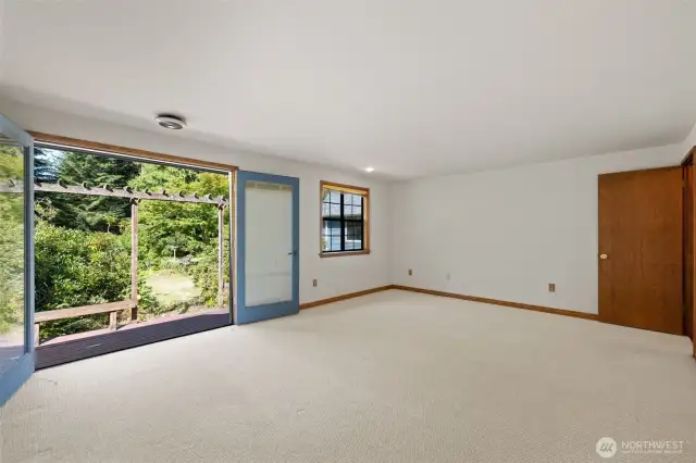 Generous Primary suite with french doors leading to back yard gardens.