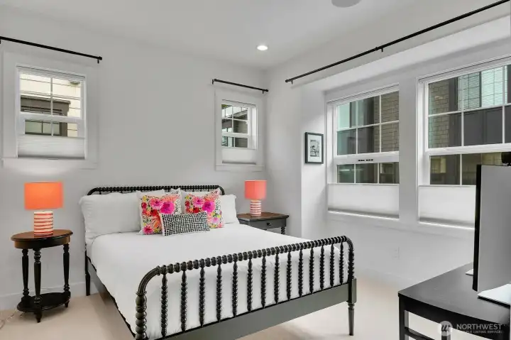 The guest room enjoys the same wool carpet and lots of windows.