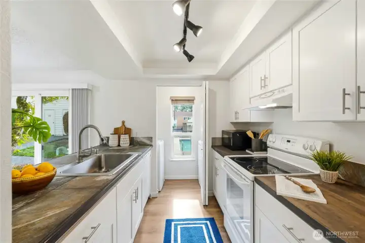 The remodeled kitchen has new cabinets with brushed nickel hardware, custom tile and butcher bock counter tops. New SS sink and fixtures, new appliances including washer and dryer.