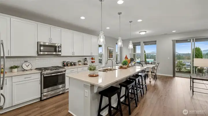The kitchen anchors the living space with quartz countertops and designer touches