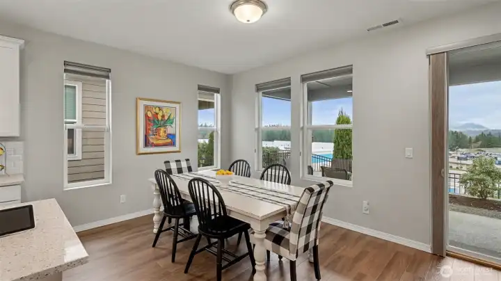 Dining area adjacent from the kitchen with mountain views and access to the covered outdoor patio