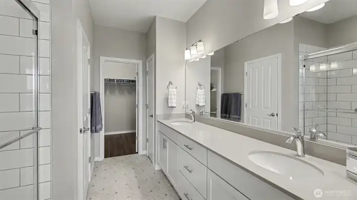 Spa like primary bathroom with a massive walk-in closet