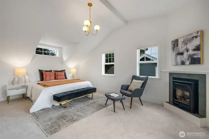 Primary suite upstairs with vaulted ceilings and gas FP