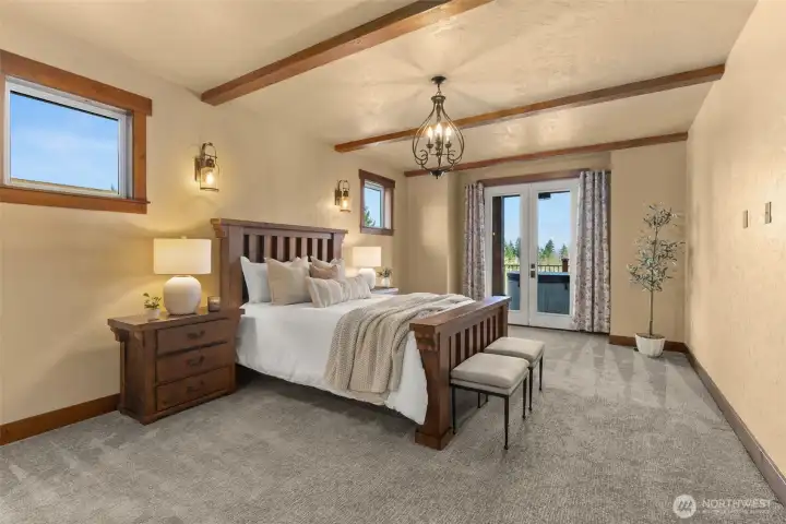Primary Suite with sliding door to covered deck and hot tub.