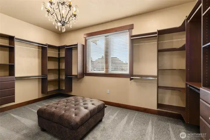 Primary walk in closet with built ins