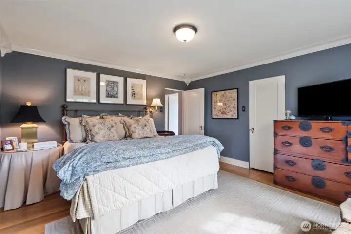 The primary bedroom is spacious and reflects the timeless elegance that defines this home.