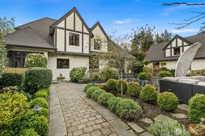The back of the house is a paradise—plenty of hardscape walkways and patios, framed by lush garden surrounds.