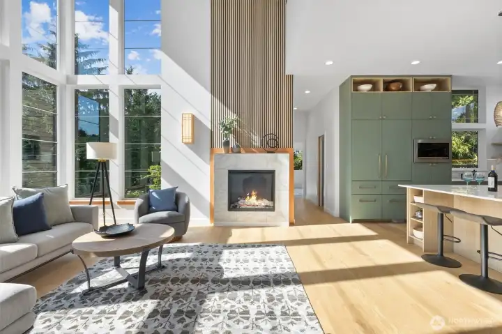 Custom fireplace with stained-glass window above from the home's original garage.