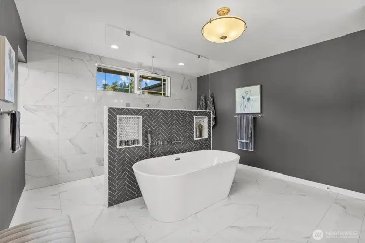 Primary bathroom is spa-inspired with separate soaking tub and shower.