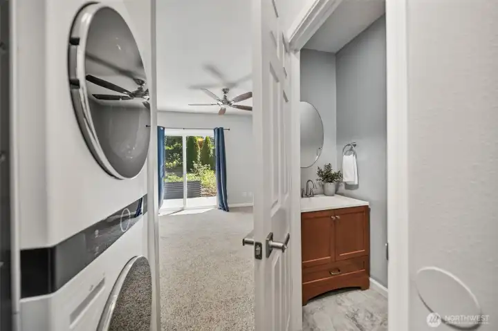Entering from the garage is a half bath and stacked washer, dryer, leading into family room. Entering from the garage is a half bath and stacked washer, dryer, leading into family room.