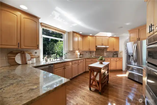This expansive chef's kitchen is any cooks dream. Beautiful solid granite counter tops, full backsplash, stainless steel appliances including Wolf range, convection microwave oven, warming drawer, brand new refrigerator & 60 bottle wine fridge. Solid hardwood flooring top this off. Just a must see!