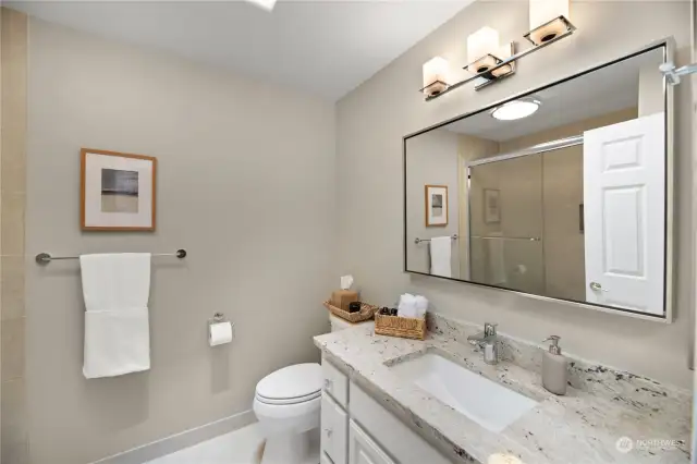 Updated full guest bathroom. Note- there is a traditional laundry shoot behind the picture on the wall. Laundry shoot goes directly to the main floor laundry cabinet.