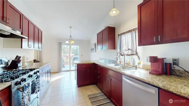 Gas stove, cherry cabinets and tons of counter space for cooking and storage for those who love to cook.