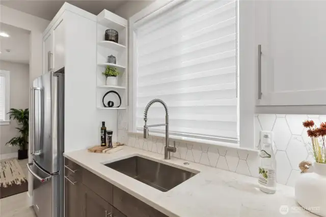 Undercabinet lights, large single bowl sink, and huge kitchen window are highlights of this home!