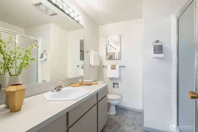 En suite primary bath with walk - in shower