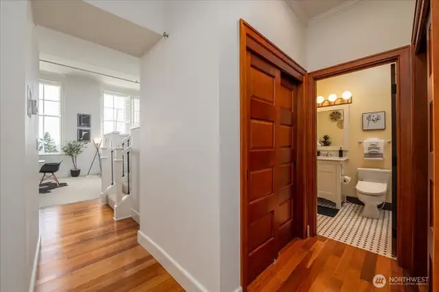 Thoughtfully Designed Hallway with Wardrobes on Both Sides and In-Unit Laundry Hookup