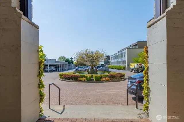 Elegant Courtyard Entrance Featuring a Fountain and Convenient Exterior Parking
