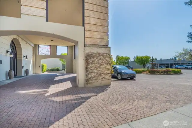 Elegant Courtyard Entrance Featuring a Fountain and Convenient Exterior Parking