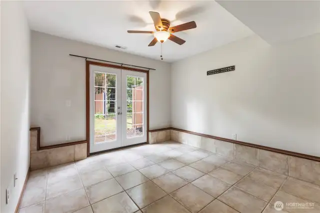 4th bedroom downstairs with ceiling fan has french doors that lead out to the backyard