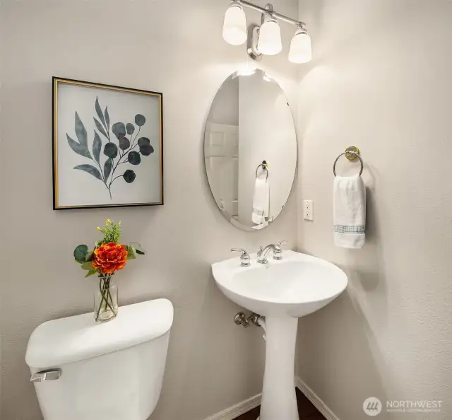 Main floor half bath with a pedestal sink.
