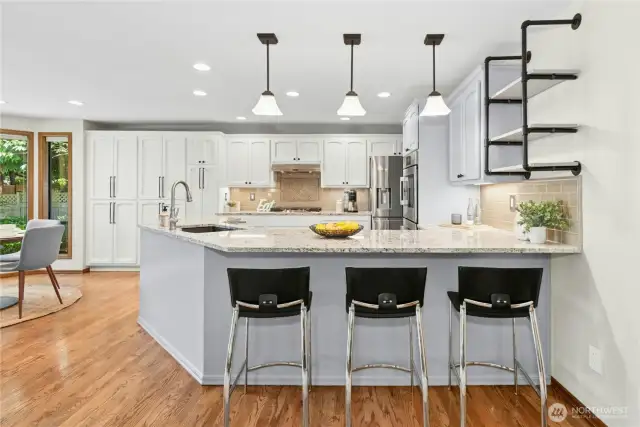 pendant lighting over breakfast bar, newer gas cooktop, bosch DW in updated kitchen