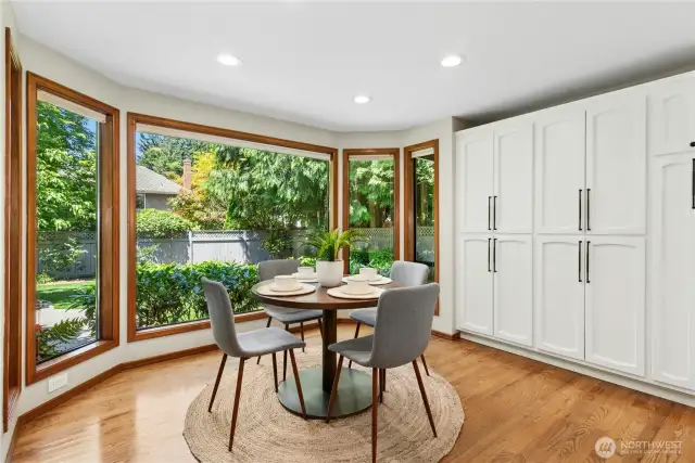 dining nook surrounded a wall of stoage and windows looking out to lush landscapes