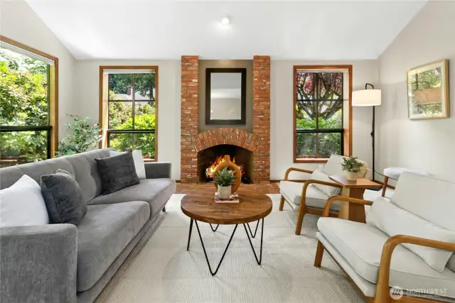 a cozy outlook with windows to greenery and gas fireplace
