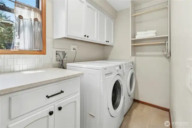 laundry room with sink, washer, dryer and storage