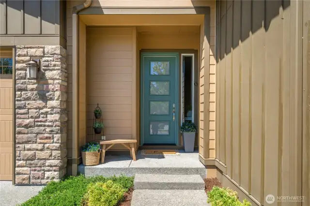 Lovely entry with upgraded front door, side light window and stacked stone accent.