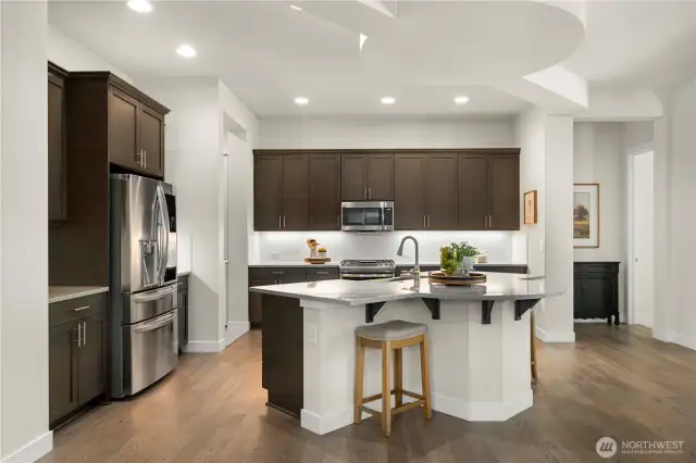 Stunning and timeless kitchen with upgraded appliances, Quartz counters and full height backsplash.