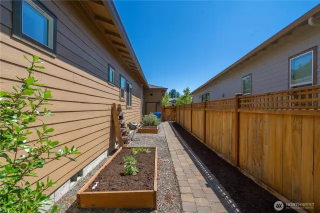 Finished with pavers and planter boxes. The South side of the property gets great exposure to plant your favorite veggies.