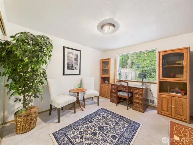 One of the 4 bedrooms are located on the main level. Here staged as an office, you can do your homework or work with a view of the back yard.