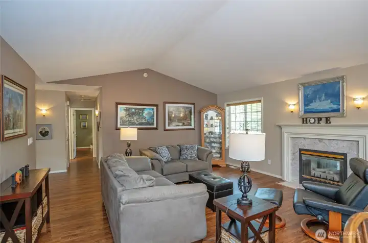 A different perspective of the living room, showing the hallway that leads to the bedrooms.