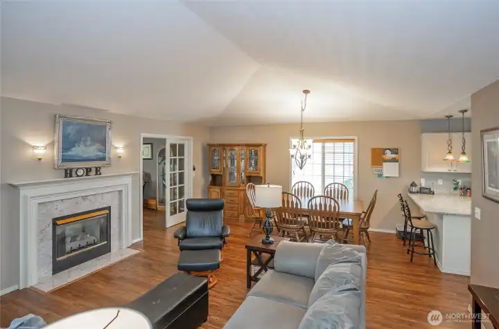 Cozy double-sided fireplace connects the living and family rooms.