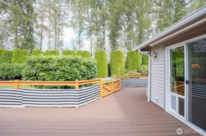 Access the deck from both the primary suite and family room—each sliding door includes a convenient doggy door.