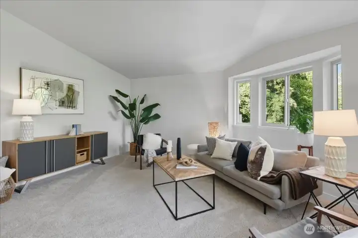HUGE living room area with vaulted ceilings and a cute window seat area.
