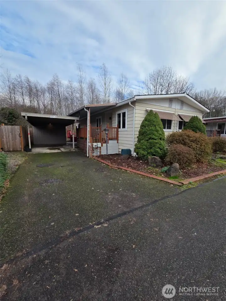 Plenty of parking! One spot under the carport with covered access to the ramp leading to the front deck/door. There is also a shed for storage! Welcome home!