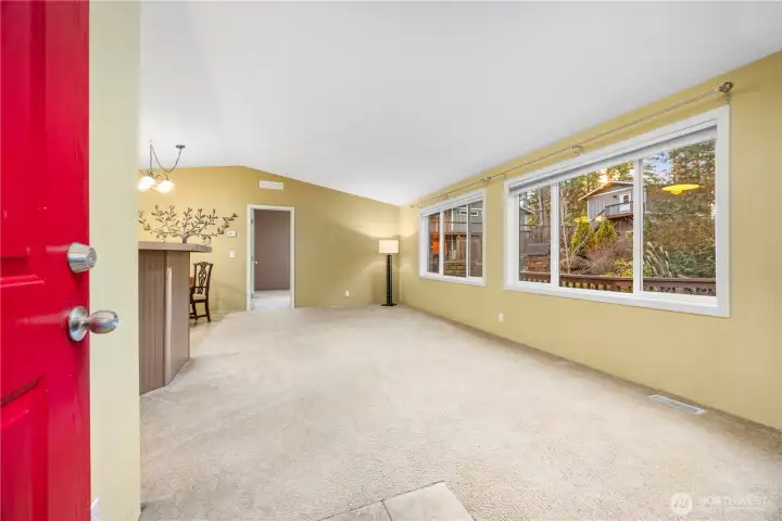 The living room is full of natural light and overlooks the stream.