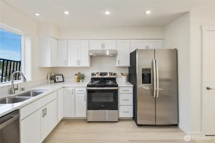 Well-appointed kitchen featuring stainless steel appliances, ample storage, and clean modern finishes ideal for everyday living.